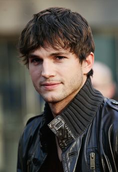 a young man wearing a black leather jacket