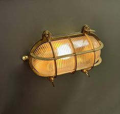 an old fashioned light fixture on the side of a wall in a room with dark walls