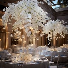 an elegant wedding setup with white flowers and chandeliers