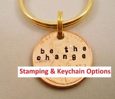 a penny keychain with the words be the change on it and an image of george