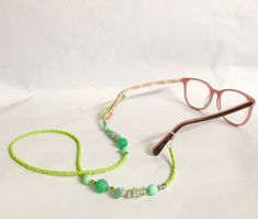 Beaded Glasses Chain - Garden Green Handmade with beautiful bright green seed beads, some sparkly and silver and crystal beads. Are you tired of walking all over the house or garden looking for your glasses? with a pretty glasses chain you'll always know where your glasses are and you'll be adding a touch of bling to your look. Measures 67cm in length   FREE SHIPPING WITHIN AUSTRALIA Follow me on Instagram: https://www.instagram.com/mollyand.frankie/ Made in Byron Bay Trendy Green Glasses Chains For Beach, Handmade Green Glass Bead Glasses Chains, Beaded Green Glasses Chains For Beach, Beaded Green Glasses Chains For The Beach, Green Beaded Glasses Chain Gift, Green Beaded Glasses Chain As Gift, Green Round Beaded Glasses Chains For Gifts, Handmade Green Glasses Chains With Round Beads, Green Beaded Chain Glasses For Gift