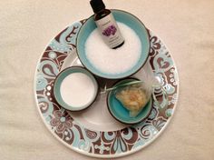 a plate topped with two bowls filled with food next to a bottle of lotion