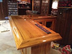 a wooden desk in a room with many bookshelves