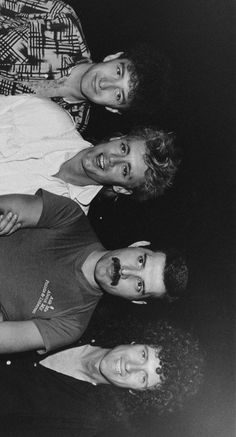 black and white photograph of three men sitting next to each other