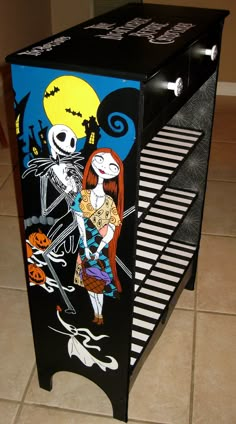 a black and white cabinet with a skeleton on it's side, painted to look like jack skellingy