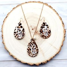 This personalized leopard print jewelry set makes a great gift for any special occasion in your life. A beautiful pebbled texture makes it very easy to complement any wardrobe choice with these. The small pearl pendant on the front of the necklace gives a subtle classy look. The embroidery threads on the back are trimmed close and neat for a professional look.  Each piece measures 2 1/2" length by 1 5/8" width in a teardrop shape. Chain length is 28 inches long with a 3 inch extension on the end. The color appeares on both sides of the earring. The hooks and chain are french style and nickle free.  The personalization on these is stitched, NOT vinyl. Please be sure to leave your choice of letter in the personalization box during purchase. If you are needing another color besides white for Trendy Personalized Jewelry For Mother's Day, Trendy Jewelry For Mother's Day Personalized Gift, Mother's Day Adjustable Jewelry Sets Gift, Mother's Day Gift Adjustable Jewelry Sets, Trendy Leopard Print Dangle Jewelry, Elegant Brown Personalized Jewelry, Trendy Dangle Jewelry For Mother's Day, Handmade Jewelry Gift For Mom, Trendy Leopard Print Earrings As Gift