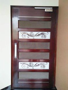 a wooden door with decorative glass panels