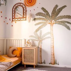 a bedroom with a palm tree painted on the wall next to a dresser and mirror