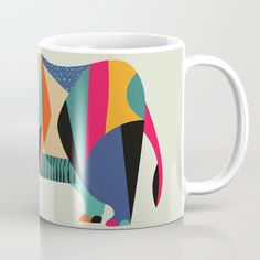 a colorful coffee mug with an elephant on the front and back side, sitting on a white surface