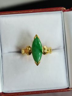 You are viewing a beautiful 24k solid gold jadeite marquise shape ring. The ring is size 4 1/4  suitable for small finger. The ring marked 24k in Chinese stamp inside  The ring itself measures approx. 17mm x 6mm wide. The band is 3mm thickness. The total weight of the  ring is 9.26 grams. The ring has a nice thickness to the name and heaviness to it...Its a pretty solid ring. The ring has a beautiful apple green jadeite jade marquise shape. Good condition . Classic Jade Jewelry For Wedding, Classic Jade Wedding Jewelry, Classic Gold Marquise Emerald Ring, Marquise Emerald Ring For Formal Occasions, Classic Marquise Emerald Ring In Gold, Marquise Emerald Ring For May Birthstone, Marquise Green Ring In 14k Gold, Green Marquise Ring In 14k Gold, Green Marquise 14k Gold Jewelry