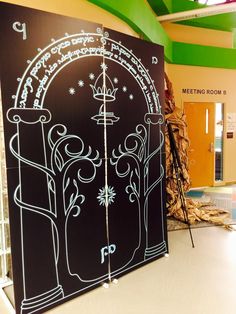 two black and white doors with writing on them in a room that has green walls