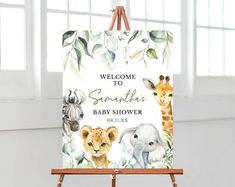 an easel with a welcome sign for a baby shower on it and two giraffes in the background