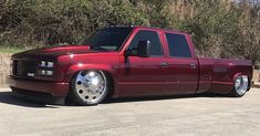 a red pick up truck parked in a parking lot