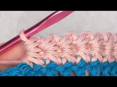 the crochet stitch is being worked on by someone using a pink knitting needle