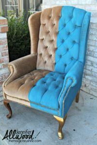 a blue and brown chair sitting in front of a brick wall