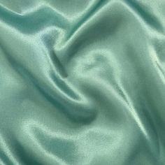 "Elevate your special occasion creations with Sedona Designz Premium Bridal Wedding Satin Charmeuse Fabric. Made from 100% polyester, this luxurious fabric boasts a lightweight feel that is both soft and smooth to the touch, making it the perfect choice for bridal gowns, bridesmaid dresses, and elegant evening wear. With a width of 60 inches, this fabric provides ample material for crafting exquisite garments that drape beautifully and exude sophistication. This high-quality satin charmeuse fabr Pastel Green Fabric, Christmas Showcase, Elegant Evening Wear, Delicate Lingerie, Charmeuse Fabric, Gowns Bridesmaid, Flowing Fabric, Flowing Dresses, Luxurious Fabric