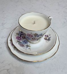 a cup and saucer with a candle on it