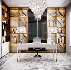 a desk with a laptop on it in front of a bookcase and chandelier