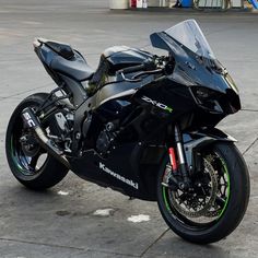 a black motorcycle parked on top of a parking lot