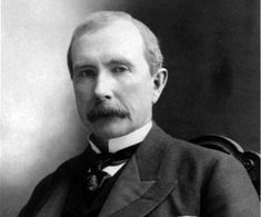 an old black and white photo of a man in a suit with a moustache