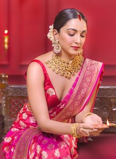 a woman in a red and pink sari