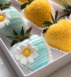 some strawberries are decorated with white flowers and green leaves on top of each other