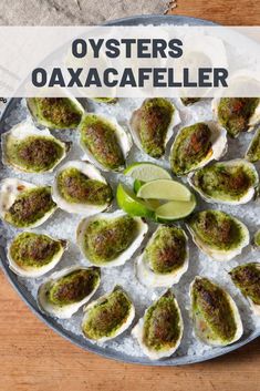 oysters on an ice - covered platter with a lime wedge and sauce in the middle