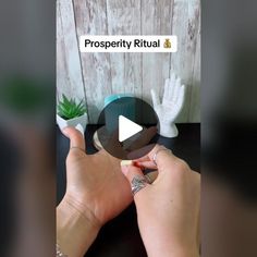 a woman is holding her fingers up to show the word prosperity ritual