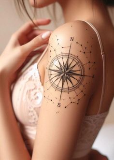 a woman with a compass tattoo on her arm