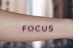 a person's arm with the word focus written on it in cursive font