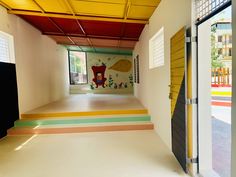 an empty room with colorful painted floors and walls