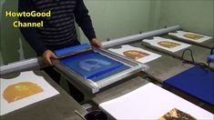 a man standing in front of a table with pictures on it