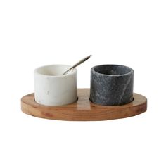 two marble bowls and a spoon on a wooden tray