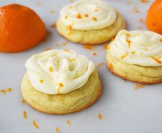 four orange cookies with white frosting and an orange