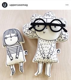 two paper dolls made to look like they are wearing glasses