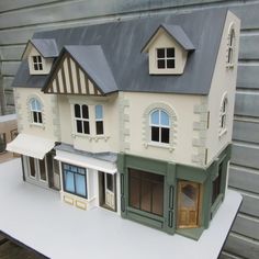 a doll house is sitting on top of a table