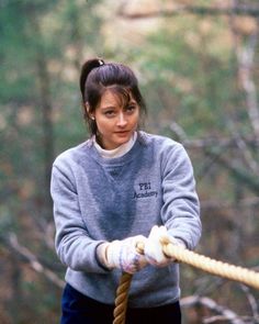 a woman holding a rope in her hands