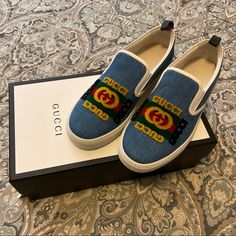 Brand New In Box, Dust Bags And Papers. Sold Out In Stores And Hard To Find On These Size. 100% Authentic. Gucci Kura Denim Slip On Sneaker With Gucci Patch. Mens Sz 8. Please Check You Sizing Accordingly To The Brand If You Never Have A Pair Of Gucci Shoes. Brother Purchase For $670 Plus Tax And Never Worn. Make Offers!! Gucci Casual Slip-on Sneakers, Blue Gucci Sneakers With Branded Insole, Gucci Casual Blue Sneakers, Designer Gucci Slip-on Leather Shoes, Designer Blue Gucci Sneakers, Gucci Denim Slides, Gucci Blue Leather Sneakers, Blue Low-top Gucci Sneakers, Designer Blue Slip-on Sneakers