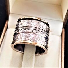 9K Gold and Silver Spinner Ring with Zircons and Flowers Decoration. In This Ring, 3 Spin Rings: 1 Stud with Zircon Stones & 2 Decorated Hammered Sterling Silver 925. Description: ❇ Free worldwide shipping ❇ Material: 925 Sterling Silver combined with 9K Solid Gold & Zirconia Stones. ❇ Bands Width: 1.7cm (0.66 inches). . ❇ All Jewelry items are shipped inside a fancy gift box. ❇ All of my designs are HANDMADE. New !! Now you can engrave your beloved's one name with a laser in the inner s Jewish Wedding Rings, Gold And Silver Ring, Wide Wedding Rings, Floral Wedding Ring, Two Tone Ring, Black Tourmaline Ring, Flowers Decoration, Wide Band Ring, Fancy Gifts