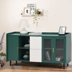 a green and white sideboard in an office with a lamp on top of it