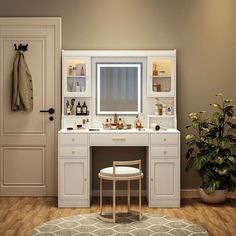 a bathroom with a vanity, mirror and stool in front of a potted plant