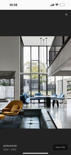 an image of a living room with furniture on the floor and windows in the background