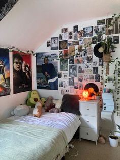 a bed room with a neatly made bed and pictures on the wall