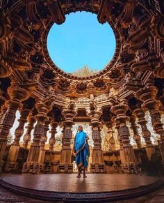 a man standing in the middle of an ornate building