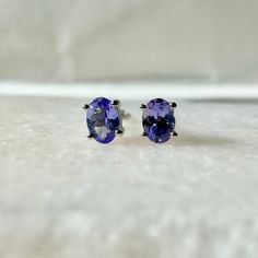 A timeless and classic design, symbolizing serenity, balance, and emotional healing. Perfect for everyday wear or dressed up for special occasions. Add a pop of color with our Genuine Tanzanite Oval Cut Stud Earrings, available in 14k solid white gold and 14k solid yellow gold. Item Specifications: Materials: 14k Solid Gold  Gemstone: Natural Tanzanite  Tanzanite Diameter: 4 mm x 3.3 mm Earring Posts Length: 10-11 mm  Total Gold Weight: 0.57 ct. Total Tanzanite Weight: 0.38 ct. Location: Earlobe Timeless Oval Everyday Earrings, Classic Tanzanite Jewelry, Timeless Oval Earrings For Everyday, Timeless Oval Gemstone Earrings, Classic Tanzanite Earrings For Anniversary, Classic Silver Tanzanite Earrings, Classic Tanzanite Gemstone Earrings, Classic Oval Hypoallergenic Jewelry, Classic Hypoallergenic Oval Jewelry