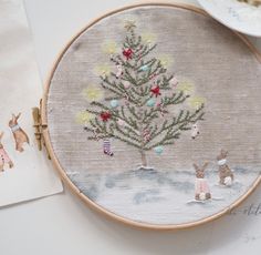 a cross stitch christmas tree on a table