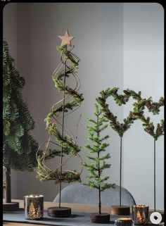 three christmas trees are arranged on a table