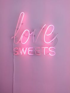 a pink neon sign that says love sweets