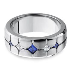 a white gold ring with three blue and white diamonds on the inside, set in 18k white gold