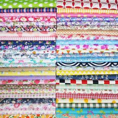 many different types of fabrics are stacked together